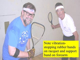 Note vibration-stopping rubber bands on racquet and support band on forearm 