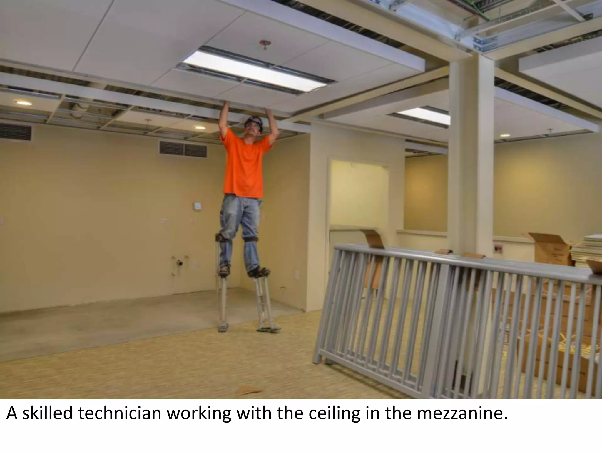 A skilled technician working with the ceiling in the mezzanine.  