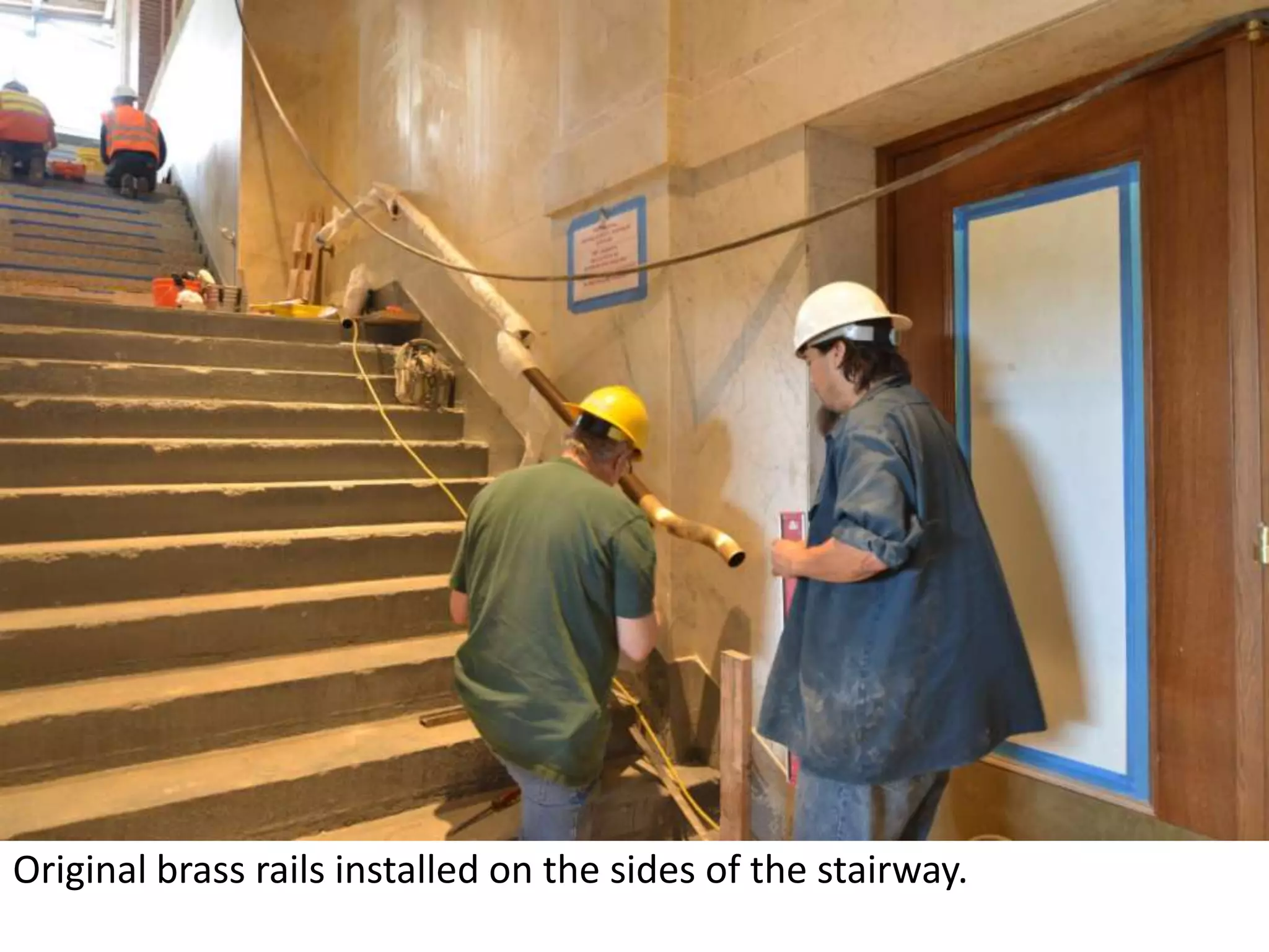 Original brass rails installed on the sides of the stairway. 