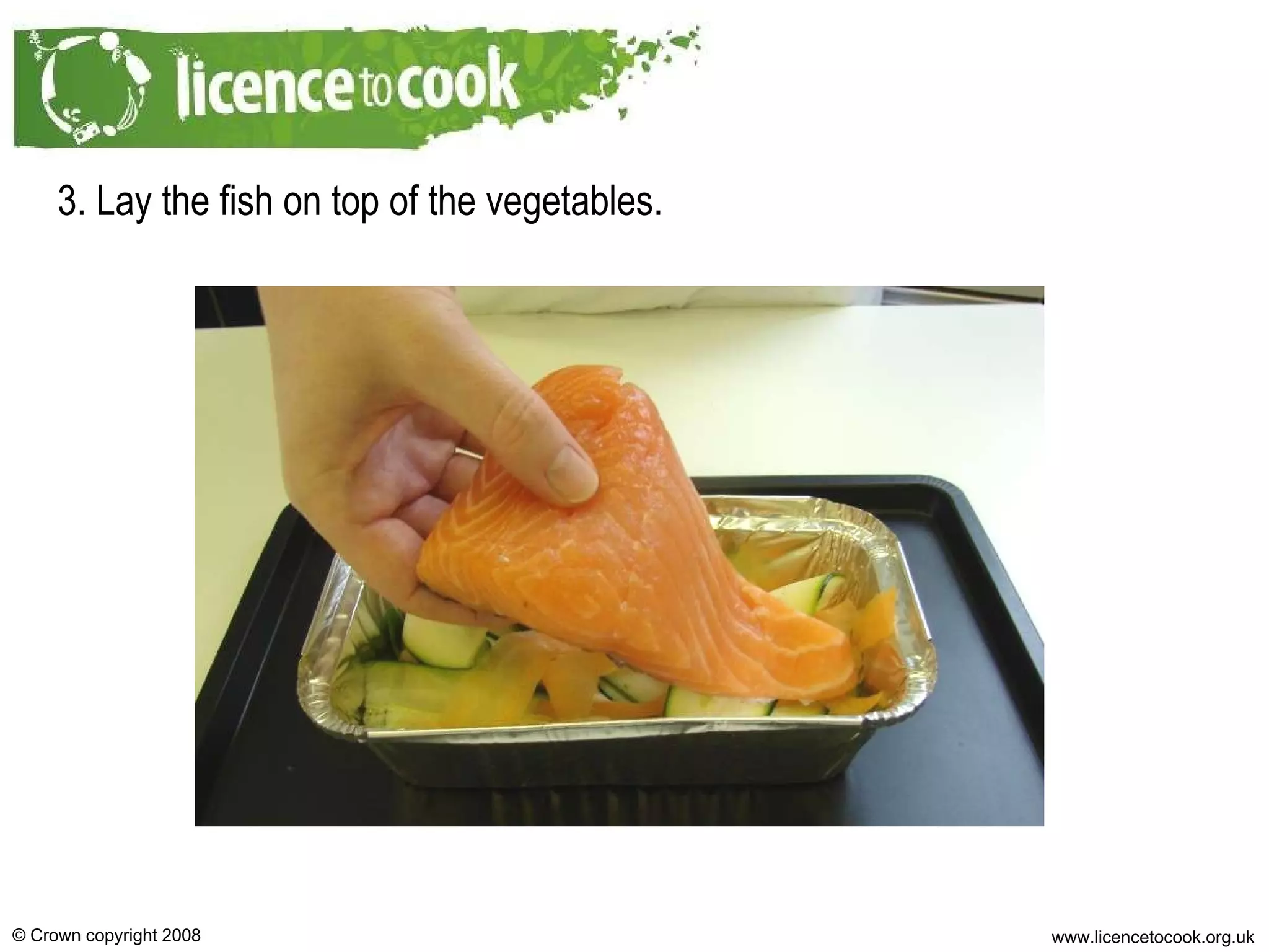3. Lay the fish on top of the vegetables. 