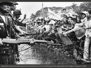 Vietnamese troops with fixed bayonets face demonstrators in front of building where the ruling military met in Saigon on August 27, 1964.
 