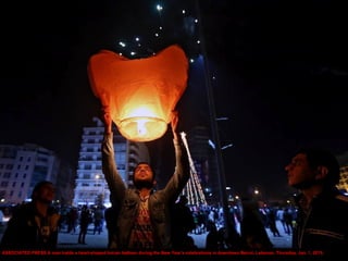ASSOCIATED PRESS A man holds a heart-shaped hot-air balloon during the New Year's celebrations in downtown Beirut, Lebanon...