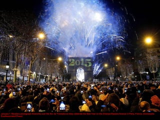 January 1: Revelers photograph fireworks over the Arc de Triomphe as they celebrate the New Year on the Champs Elysees Ave...