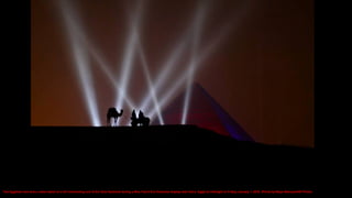Two Egyptian men and a camel stand on a hill overlooking one of the Giza Pyramids during a New Year's Eve fireworks display near Cairo, Egypt at midnight on Friday, January 1, 2016. (Photo by Maya Alleruzzo/AP Photo)
 