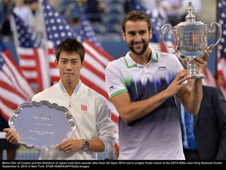 The media photograph Marin Cilic of Croatia as he celebrates 
with the trophy after defeating Kei Nishikori of Japan to wi...