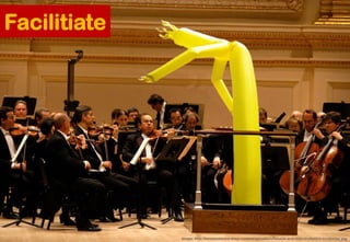Facilitiate
Image: http://haveyouheard.it/wp-content/uploads/inflatable-arm-man-orchestra-conductor.jpg
 