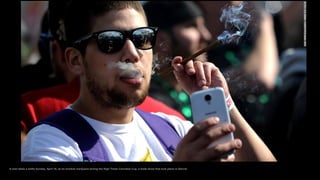 A man takes a selfie Sunday, April 19, as he smokes marijuana during the High Times Cannabis Cup, a trade show that took p...