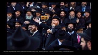 A rabbi uses a selfie stick near the Chabad-Lubavitch headquarters in New York on Sunday, November 8. Thousands of Orthodo...