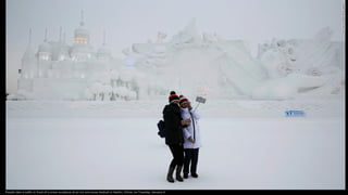 People take a selfie in front of a snow sculpture at an ice and snow festival in Harbin, China, on Tuesday, January 5.
 