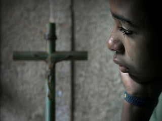 Boy Pondering Cross
 