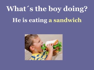 What´s the boy doing? He is eating  a sandwich 