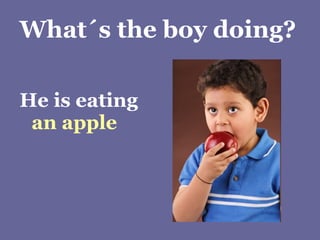 What´s the boy doing? He is eating  an apple 