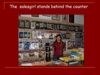 The salesgirl stands behind the counter
 
