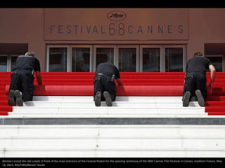 Workers install the red carpet in front of the main entrance of the Festival Palace for the opening ceremony of the 68th C...