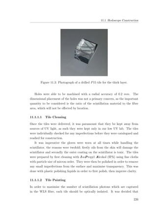 11.1. Hodoscope Construction
Figure 11.3: Photograph of a drilled P15 tile for the thick layer.
Holes were able to be machined with a radial accuracy of 0.2 mm. The
dimensional placement of the holes was not a primary concern, as the important
quantity to be considered is the ratio of the scintillation material to the ﬁbre
area, which will not be eﬀected by location.
11.1.1.1 Tile Cleaning
Once the tiles were delivered, it was paramount that they be kept away from
sources of UV light, as such they were kept only in our low UV lab. The tiles
were individually checked for any imperfections before they were catalogued and
readied for construction.
It was imperative the gloves were worn at all times while handling the
scintillator, the reasons were twofold; ﬁrstly oils from the skin will damage the
scintillator and secondly the outer coating on the scintillator is toxic. The tiles
were prepared by ﬁrst cleaning with I soPropyl Alcohol (IPA) using ﬁne cloths
with particle size of micron order. They were then be polished in order to remove
any small imperfections from the surface and maximise transparency. This was
done with plastic polishing liquids in order to ﬁrst polish, then improve clarity.
11.1.1.2 Tile Painting
In order to maximise the number of scintillation photons which are captured
in the WLS ﬁbre, each tile should be optically isolated. It was decided that
226
 