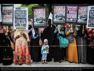 Malaysian Muslim activists display pickets during a protest against the upcoming visit of President Barack Obama outside t...