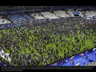 Football fans gather on the field of the Stade de France stadium following the friendly football match between France and ...