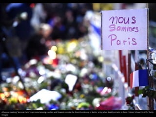 A banner reading ‘We are Paris ’ is pictured among candles and flowers outside the French embassy in Berlin, a day after d...