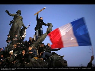 A man holds a giant pencil as he takes part in a Hundreds of thousands of French citizens solidarity march (Marche Republi...