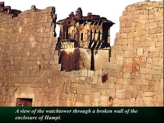 A view of the watchtower through a broken wall of the
enclosure of Hampi.
 