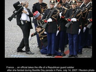 France ... an official takes the rifle of a Republican guard soldier after she fainted during Bastille Day parade in Paris, July 14, 2007 / Reuters photo  