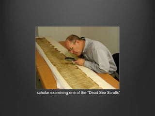 scholar examining one of the "Dead Sea Scrolls"
 