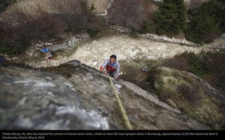 Temba Sherpa, 45, who has reached the summit of Everest seven times, climbs to clean the mani (prayer) stone in Khumjung, approximately 12139 feet above sea level in
Solukhumbu District May 8, 2014.
 