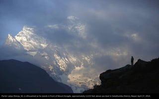 Porter Lakpa Sherpa, 42, is silhouetted as he stands in front of Mount Kongde, approximately 11155 feet above sea level in Solukhumbu District, Nepal, April 27, 2014.
 