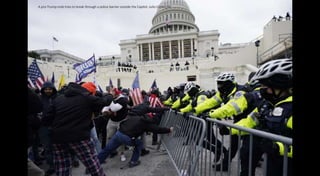 A pro-Trump mob tries to break through a police barrier outside the Capitol. Julio Cortez/AP
 