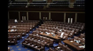 Papers and gas masks left behind after members of Congress were forced to evacuate. J Scott Applewhite/AP
 