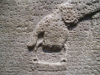 Assyrian Writing/Languages The first ancient Assyrian alphabet was called Akkadian.  This language originated in 2300 B.C. when the first Akkadian king spread the language across the land he possessed and later on the language diffused furthermore.  This writing system was written on clay tablets called cuneiforms.  Cuneiforms were used until approximately 750 B.C.  They consist of strokes, which are engraved into clay, wax, metal, or stone and were used for 3,000 years.  The Akkadian language consisted of an average of 600 signs, words or syllables.  The sound system was made up of 20 consonants and 4 vowels, which in English are known as (a, i, e, u). The second language that was spoken by the people of Assyria originated in 725 B.C.  This system was called Aramaic.  Aramaic is based off of the former Assyrian language, Akkadian, and many words from each language are similar to one another.  background: figure 3 