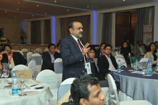 An attendee posing a question to the panelists during the Panel Discussion