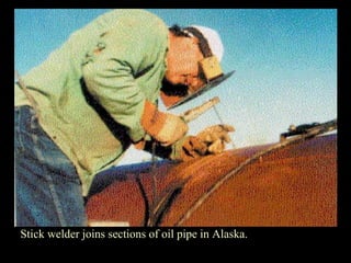 Stick welder joins sections of oil pipe in Alaska.
 
