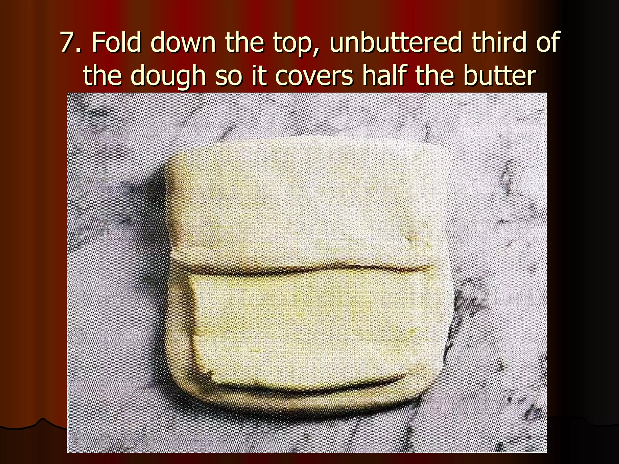 7. Fold down the top, unbuttered third of the dough so it covers half the butter 