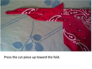 Press the cut piece up toward the fold.
 