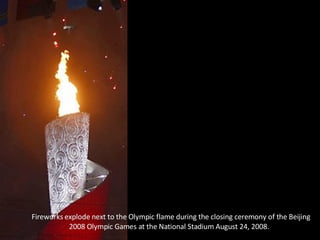  Fireworks explode next to the Olympic flame during the closing ceremony of the Beijing 2008 Olympic Games at the National Stadium August 24, 2008.  
