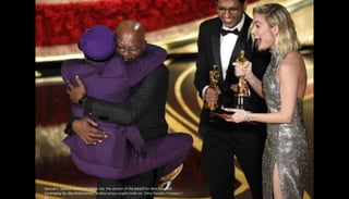 Samuel L. Jackson embraces Spike Lee, the winner of the award for Best Adapted
Screenplay for BlacKkKlansman, as Brie Lars...