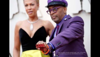 Spike Lee holds a knuckle ring that reads "Love" as he arrives
with his wife Tonya Lewis Lee. REUTERS/Mario Anzuoni
 