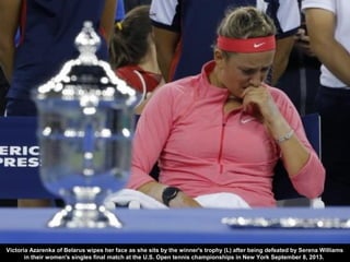 Victoria Azarenka of Belarus wipes her face as she sits by the winner's trophy (L) after being defeated by Serena Williams...