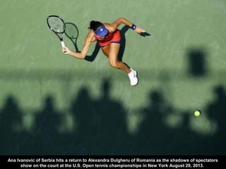 Ana Ivanovic of Serbia hits a return to Alexandra Dulgheru of Romania as the shadows of spectators
show on the court at th...