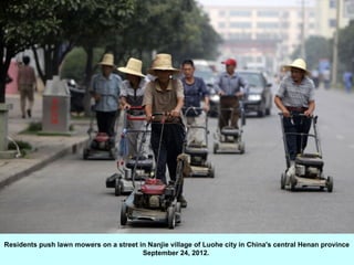 Residents push lawn mowers on a street in Nanjie village of Luohe city in China's central Henan province
                                        September 24, 2012.
 