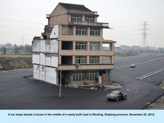 A car stops beside a house in the middle of a newly built road in Wenling, Zhejiang province, November 22, 2012.
 