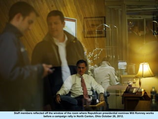 Staff members reflected off the window of the room where Republican presidential nominee Mitt Romney works
               ...