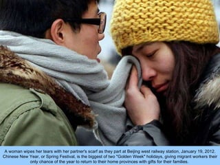 A woman wipes her tears with her partner's scarf as they part at Beijing west railway station, January 19, 2012. Chinese N...