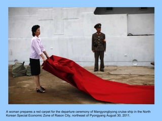 A woman prepares a red carpet for the departure ceremony of Mangyongbyong cruise ship in the North Korean Special Economic Zone of Rason City, northeast of Pyongyang August 30, 2011.  