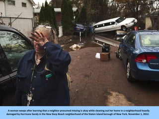 A woman weeps after learning that a neighbor presumed missing is okay while cleaning out her home in a neighborhood heavil...