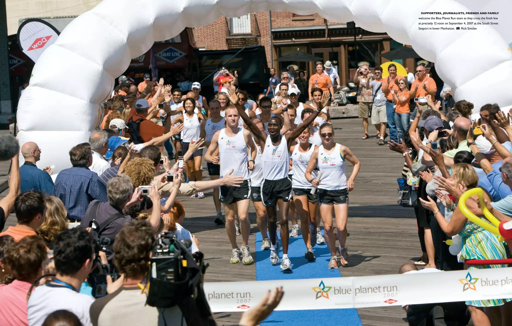  Supporters, journalists, friends and family
welcome the Blue Planet Run team as they cross the finish line
at precisely 12 noon on September 4, 2007 at the South Street
Seaport in lower Manhattan.      Rick Smolan
 