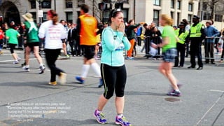 A woman looks on as runners pass near
Kenmore Square after two bombs exploded
during the 117th Boston Marathon. ( Alex
Trautwig/Getty Images) #
April 24, 2013 12
 