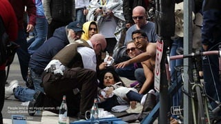 People tend to an injured woman. (Bill
Greene/Globe Staff) #
April 24, 2013 23
 