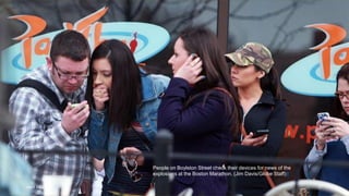 People on Boylston Street check their devices for news of the
explosions at the Boston Marathon. (Jim Davis/Globe Staff)#
April 24, 2013 27
 